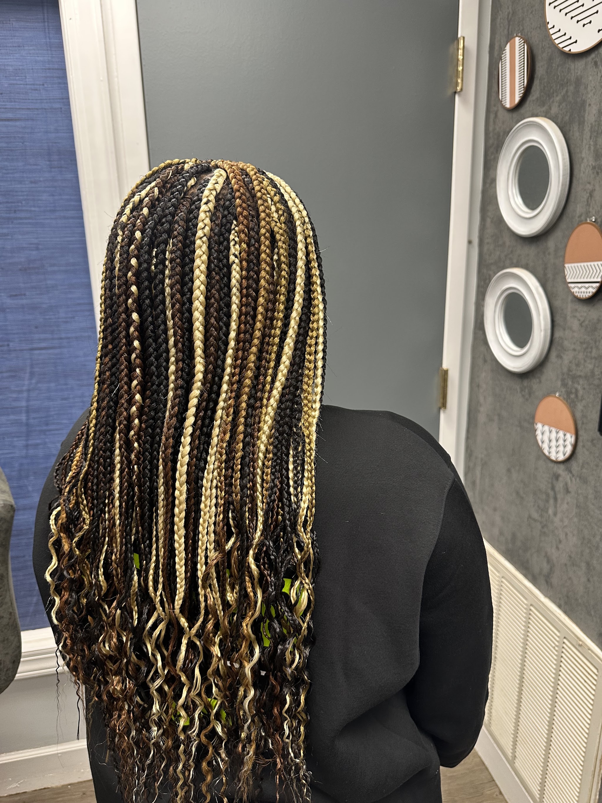 Blonde and brown box braids with curly ends