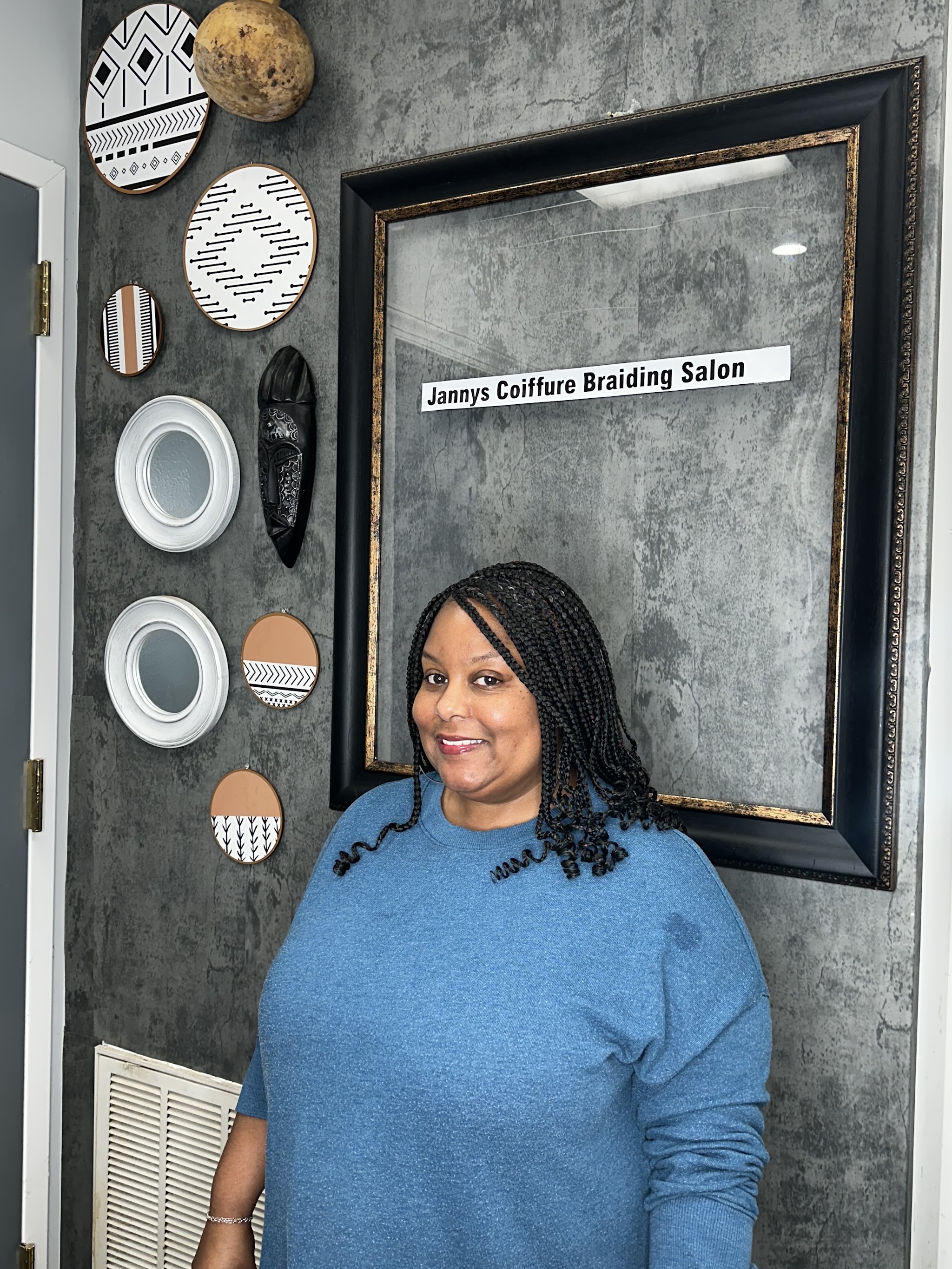 Twists styled to one side, client smiling at the camera