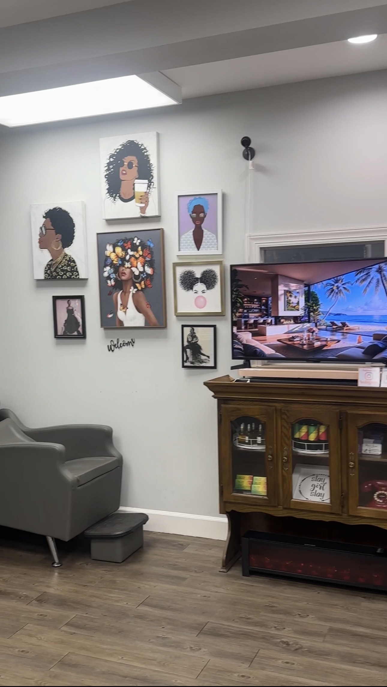 Salon wall with framed portraits and a waiting area